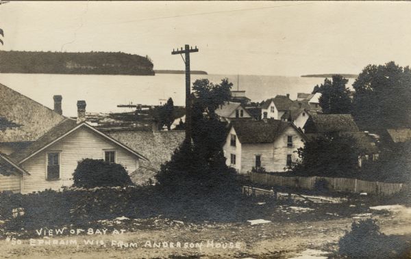 Elevated view of the bay side neighborhood, with a view of the bluffs across the bay. Caption reads: "View of Bay at Ephraim from Anderson's House."