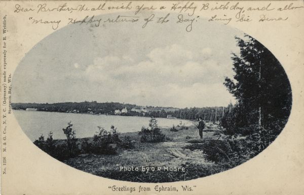 Oval framed view of Ephraim from across the bay. A man is standing in the foreground. Caption reads: "Greetings from Ephraim, Wis."