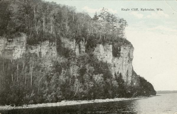 View from water towards Eagle Cliff (Bluff) in Peninsula State Park  Caption reads: "Eagle Cliff, Ephraim, Wis."