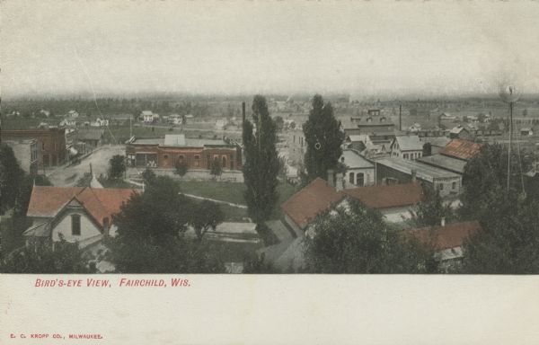 Hand-colored view over rooftops of Fairchild. Commercial buildings are in the foreground, and dwellings are in the background. Caption reads: "Bird's-Eye View, Fairchild, Wis."