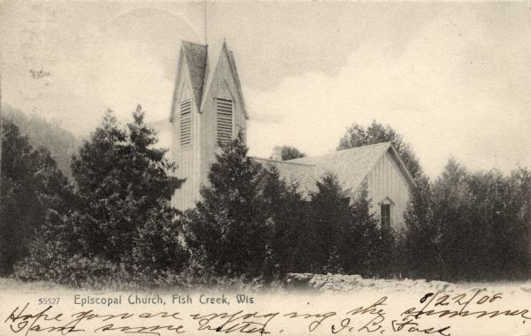 View across field towards the Episcopal Church, which is obscured by trees. Caption reads: "Episcopal Church, Fish Creek, Wis."