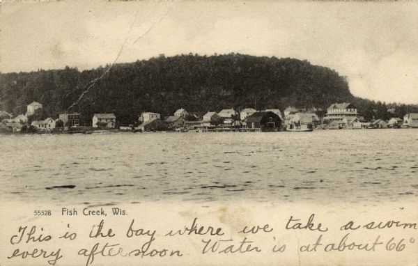 View of Fish Creek from the bay, with the main dock in the center, and the White Gull Inn on the right. Caption reads: "Fish Creek, Wis."