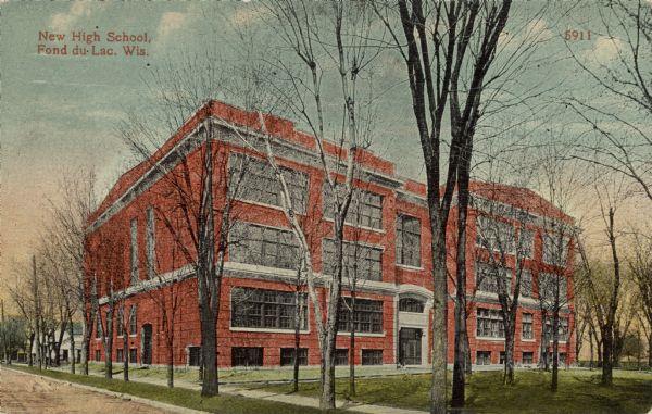 The high school, a four-story red brick building. Caption reads: "New High School, Fond du Lac, Wis."