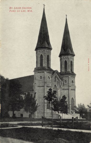 A brick church with twin spires. Caption reads: "St. Louis Church, Fond du Lac, Wis."