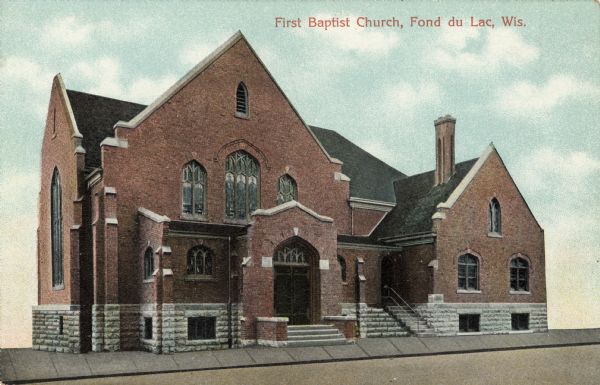 View toward the front of the church. The background has been replaced with a blue sky and clouds. Caption reads: "First Baptist Church, Fond du Lac, Wis."