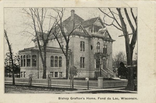 Brick Victorian home of Bishop Grafton, with a fenced-in yard. Caption reads: "Bishop Grafton's Home, Fond du Lac, Wisconsin."
