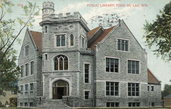 View toward the library, a three-story stone building with stained glass windows. Caption reads: "Public Library, Fond du Lac, Wis."
