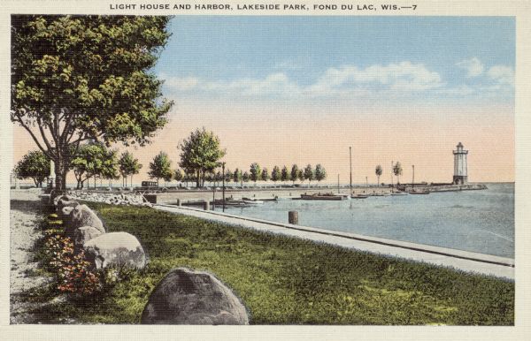 View of the lake front at Lakeside Park, with a lighthouse and docked boats. Caption reads: "Light House and Harbor, Lakeside Park, Fond du Lac, Wis."