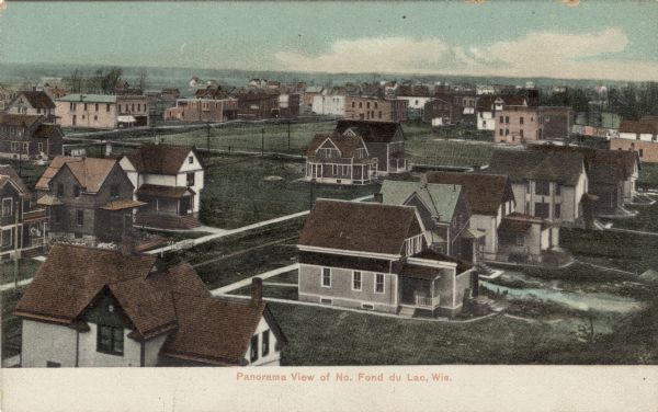 Elevated view of Fond du Lac, with a residential neighborhood in the foreground. Caption reads: "Panorama View of No. Fond du Lac, Wis."