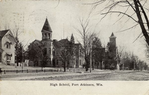 View across road toward the high school which has a bell tower. Caption reads: "High School, Fort Atkinson, Wis."