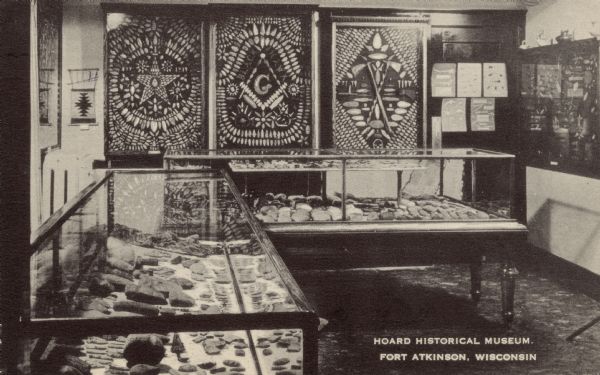 Interior view of the "Indian Room" at the Hoard Historical Museum. Display cases and wall arrangements are of arrowheads and other relics. Caption reads: "Hoard Historical Museum, Fort Atkinson, Wis."