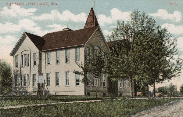 Exterior view of the high school. Caption reads: "High School, Fox Lake, Wis."