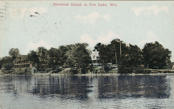View across water towards Elmwood Island, with lakeside homes. Caption reads: "Elmwood Island at Fox Lake, Wis."