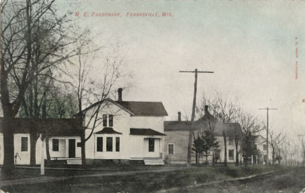 Hand-colored view of the Methodist parsonage and its surrounding neighborhood. Caption reads: "M.E. Parsonage, Franksville, Wis."