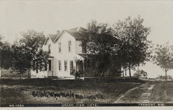 The Grand View Hotel — a two-story wood frame building with a porch along a dirt road. Caption reads: "Grand View Hotel, Fremont, Wis."