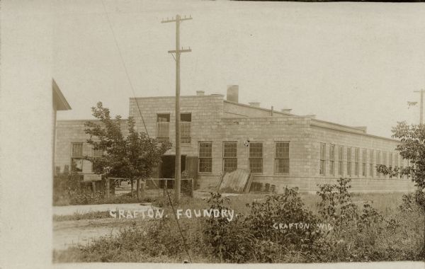 View of the Grafton Foundry — a stone factory building with many windows. Caption reads: "Grafton Foundry, Grafton, Wis."