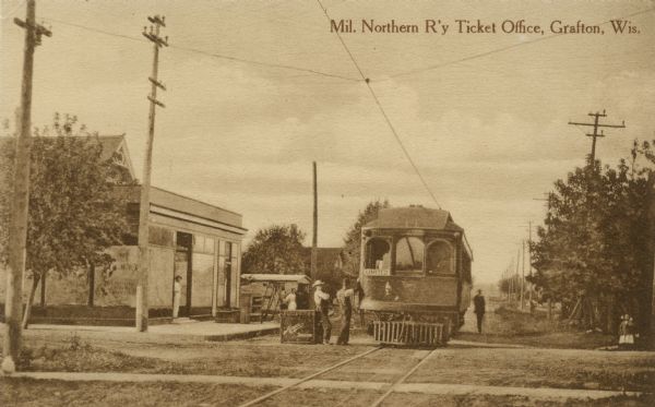Intercity Light Rail Trolley on the tracks in front of the ticket office. Caption reads: "Mil. Northern R'y Ticket Office, Grafton, Wis."