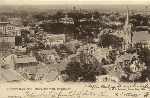 Elevated view of northeastern Green Bay. A neighborhood is in the foreground, and a large church is on the right. Caption reads: "Green Bay, Wis. Bird's Eye View, Northeast."
