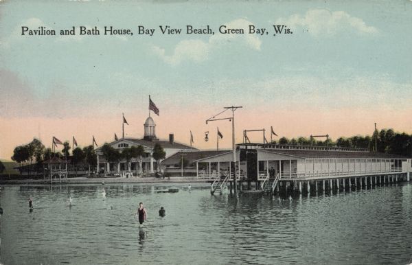 The pavilion and bath house at Bay View Beach. Bathers are walking in the shallow water in the foreground. Caption reads: "Pavilion and Bath House, Bay View Beach, Green Bay, Wis."