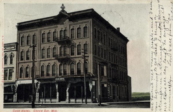View of the Cook Hotel, a four-story building with wrought iron balconies. Caption reads: "Cook Hotel, Green Bay, Wis."