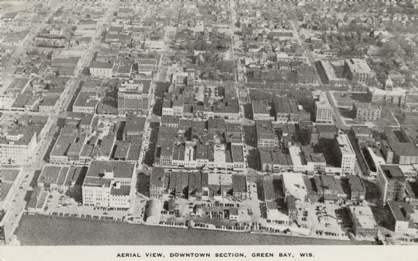 Caption reads: "Aerial View, Downtown Section, Green Bay, Wis." 
Text on reverse reads: "This aerial view shows the downtown district of the east side of Green Bay, thriving industrial and business center of northern Wisconsin."