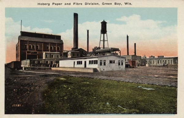 Colorized postcard of a paper factory beside a railroad track. Caption reads: "Hoberg Paper and Fibre Division, Green Bay, Wis."