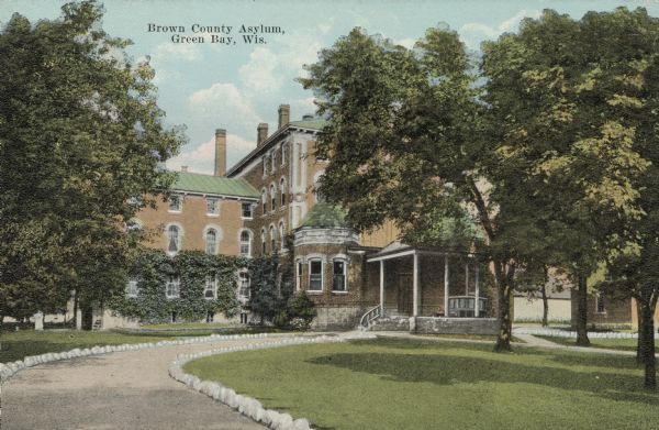 View across drive and lawn towards the front of the building. Caption reads: "Brown County Asylum, Green Bay, Wis."