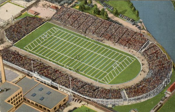 Overhead view of the football stadium before it was renamed Lambeau. The stadium is full of spectators and a game is in progress.