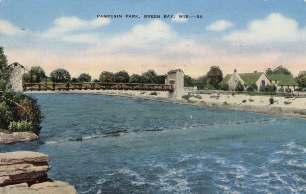 Elevated view of the bridge and main building on the opposite shoreline at Pamperin Park. Caption reads: "Pamperin Park, Green Bay, Wis."