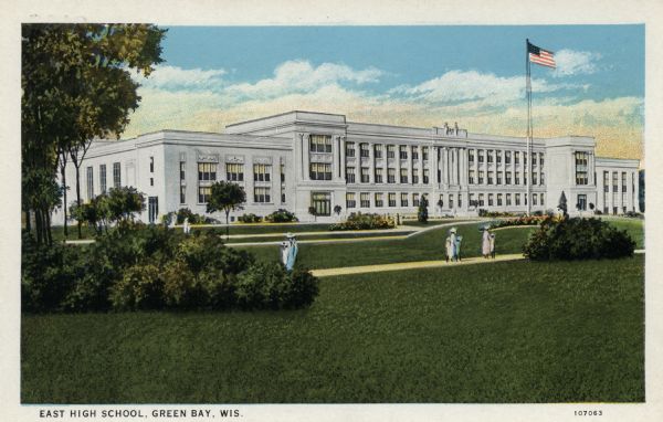 Painted view of a large high school, with pedestrians walking on a sidewalk among the grounds in front near a flag on a flagpole. 
Caption reads: "East High School, Green Bay, Wis."