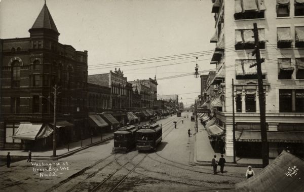 Elevated view of Washington Street, with the Mason and Monroe streetcars. The Cook Hotel is in the distance. Caption reads: "Washington Street, Green Bay, Wis."