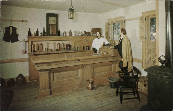 Kodachrome postcard of the barroom, with two male mannequins in period dress standing at the bar.

Text on reverse reads: "The Wade House is one of the few completely restored stage coach inns in the United States. It was completed in 1851 and served as a half-way stop for travelers between Fond du Lac and Sheboygan."