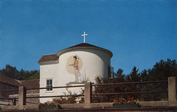 Ektachrome postcard of the Prayer Room, a converted silo in the Indian Village of the American Baptist Assembly. A depiction of a Native American man is painted on the side.