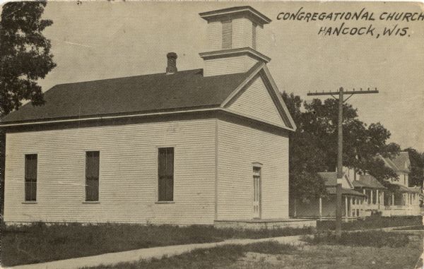 Three-quarter view towards the front and side of the Congregational Church. Houses are in the background. Caption reads: "Congregational Church, Hancock, Wis."