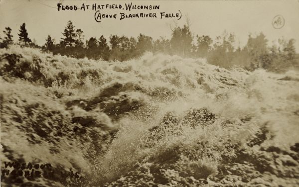 Raging high water on the Black River. Caption reads: "Flood at Hatfield (above Black River Falls)."