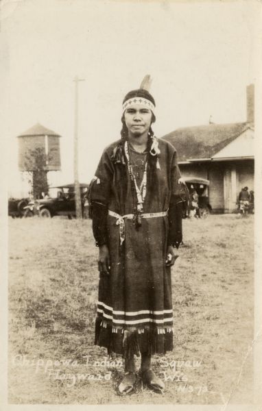 Full-length portrait of a Native American Woman (Ojibwa) wearing traditional dress. Caption reads: "Chippewa Indian Squaw, Hayward, Wis."
