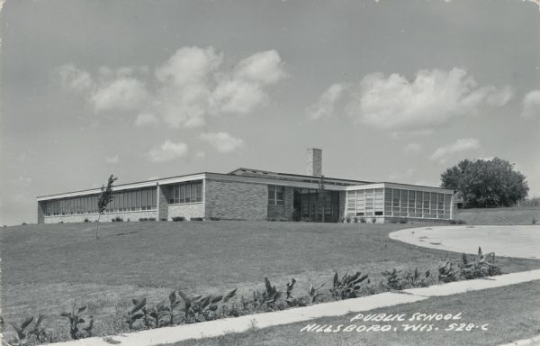 Exterior view of the public school, a brick one-story building. Caption reads: "Public School, Hillsboro, Wis."