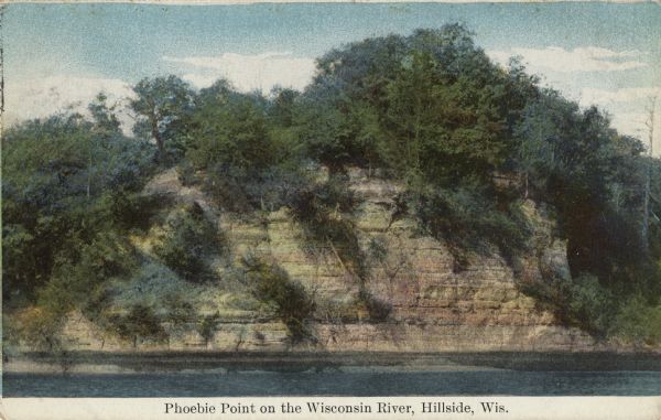 View across water towards a bluff along the Wisconsin River. Caption reads: "Phoebie Point on the Wisconsin River, Hillside, Wis."