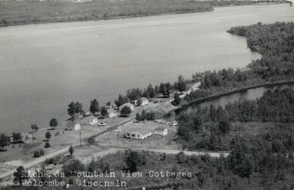Aerial view of guest cottages along Lake Holcombe. Caption reads: "Richards Mountain View Cottages, Holcombe, Wisconsin."