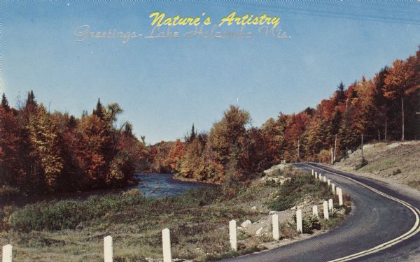Kodachrome postcard of a road of the Chippewa River during autumn. Foliage at peak color. Caption reads: "Nature's Artistry, Greetings -- Lake Holcombe, Wis."
