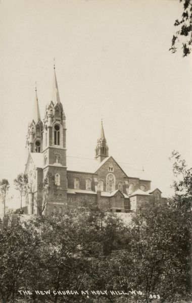 Photographic postcard view of Holy Hill Shrine of Mary soon after its construction. Caption reads: "The New Church at Holy Hill, Wis."