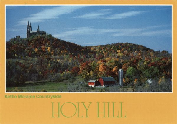 Fall view of Holy Hill on a hilltop, and a dairy farm in the foreground. Caption reads: "Kettle Moraine Countryside, Holy Hill."
