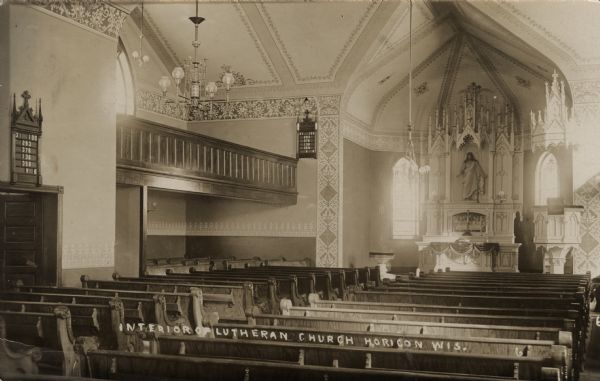 Interior view of the Lutheran Church over pews towards the altar. Caption reads: "Interior of Lutherna church, Horicon, Wis."