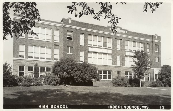 Exterior view of the high school, a three-story brick building.