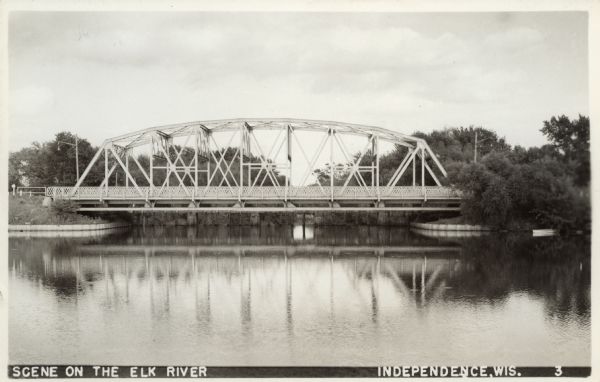 View across water towards a bridge spanning the Elk River.