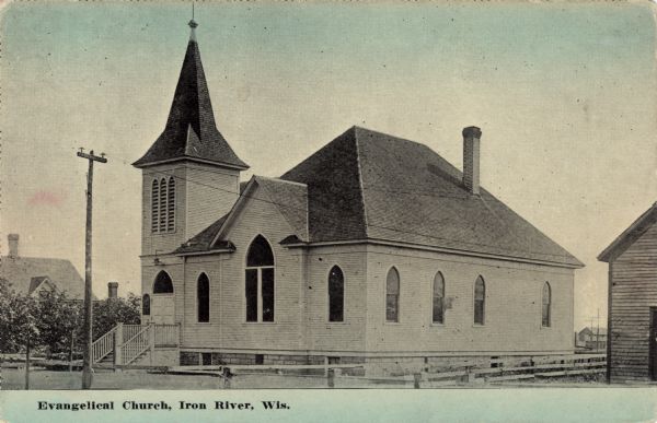 View of a wooden church with a bell tower. Caption reads: "Evangelical Church, Iron River, Wis." 