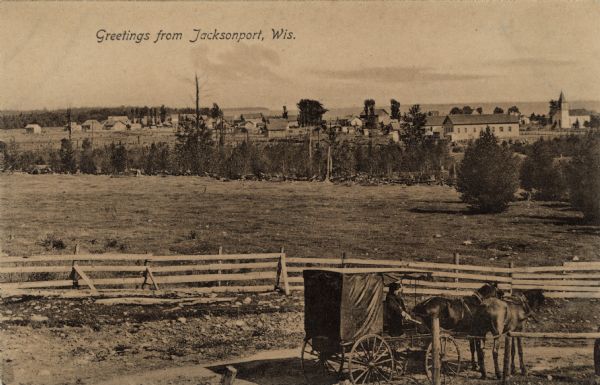 View of Jacksonport and Lake Michigan from across a pasture. A man is driving a horse-drawn vehicle in the foreground. Caption reads: "Greetings from Jacksonport, Wis."