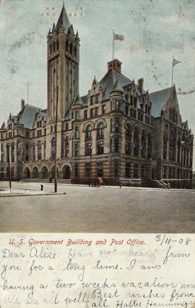 View across intersection towards the Government Building with arched entrances and turrets. Caption reads: "U.S. Government Building and Post Office."