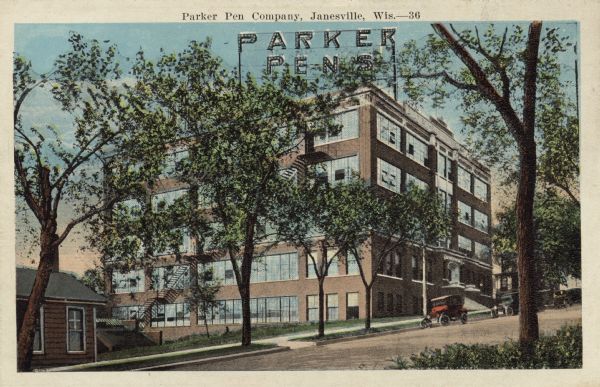 View across street towards the Parker Pen Factory, with a large, electric sign on the roof. Caption reads: "Parker Pen Company, Janesville, Wis."