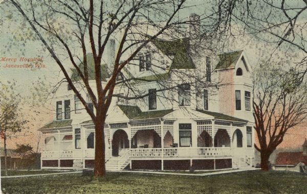 View of a large, Victorian house that functioned as a hospital. Caption reads: "Mercy Hospital, Janesville, Wis."